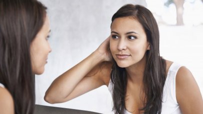 Woman checking her skin in the mirror